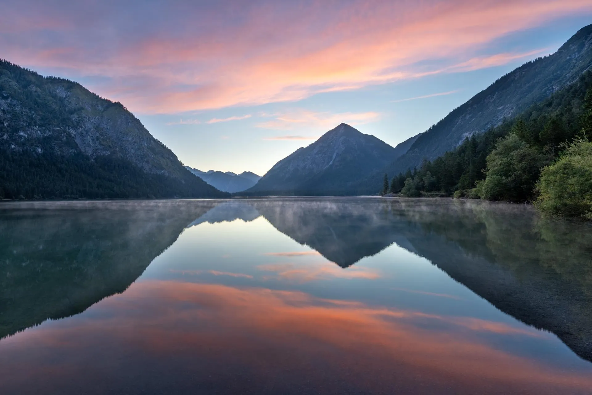 Heiterwangersee in Tyrol at sunrise, mountains reflected in the still water, shot with the Nikon Z8 and the NIKKOR Z 14-30mm f/4 S