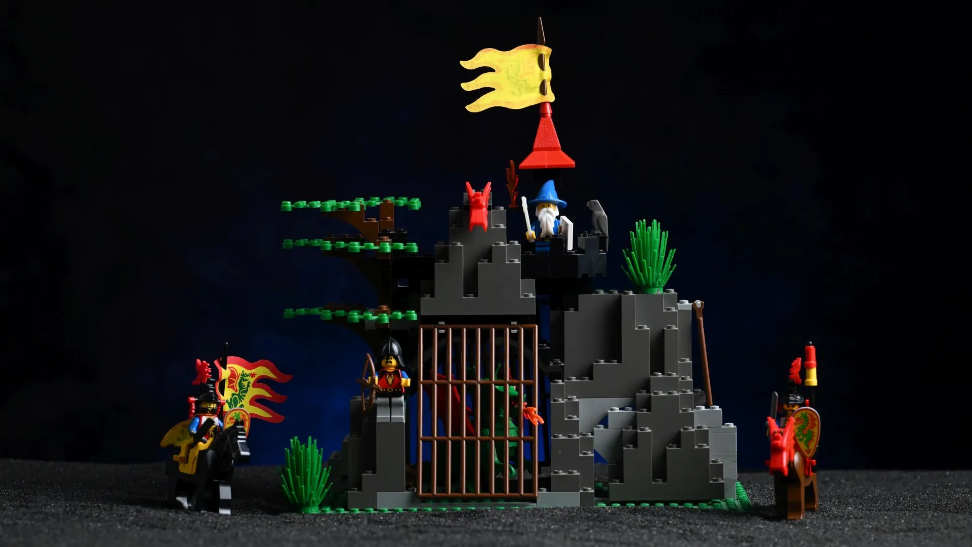 The complete LEGO Castle Dark Dragon's Den (6076) set from 1993, fully built after 33 years, with its rocky den, barred dragon cage, wizard's tower, and mounted Dragon Knights