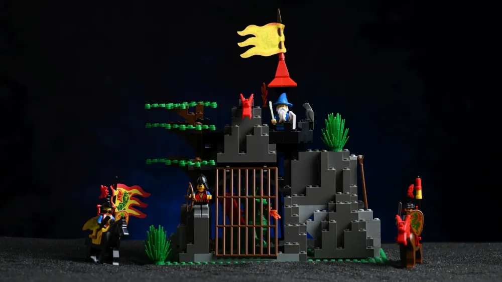 The complete LEGO Castle Dark Dragon's Den (6076) set from 1993, fully built after 33 years, with its rocky den, barred dragon cage, wizard's tower, and mounted Dragon Knights
