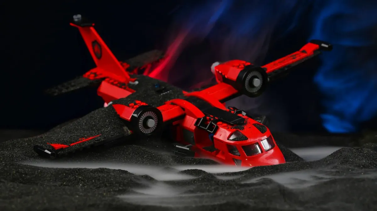 Close-up of the LEGO City Fire Rescue Plane crash-landed in black volcanic slag with drifting fog