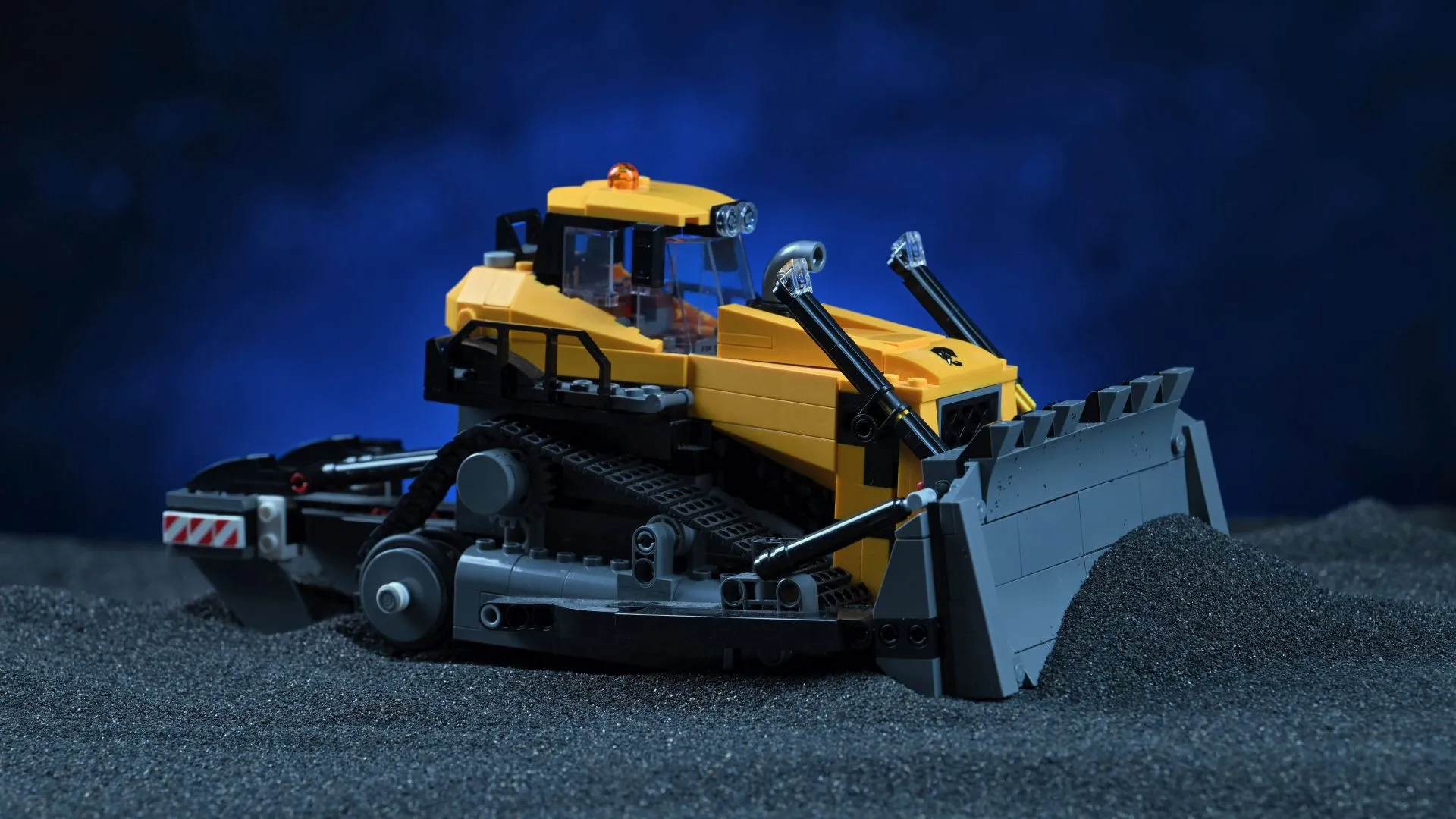 The finished LEGO City Yellow Bulldozer (60466), showing its tracked chassis, raised pusher blade and cab, staged against a dark blue backdrop