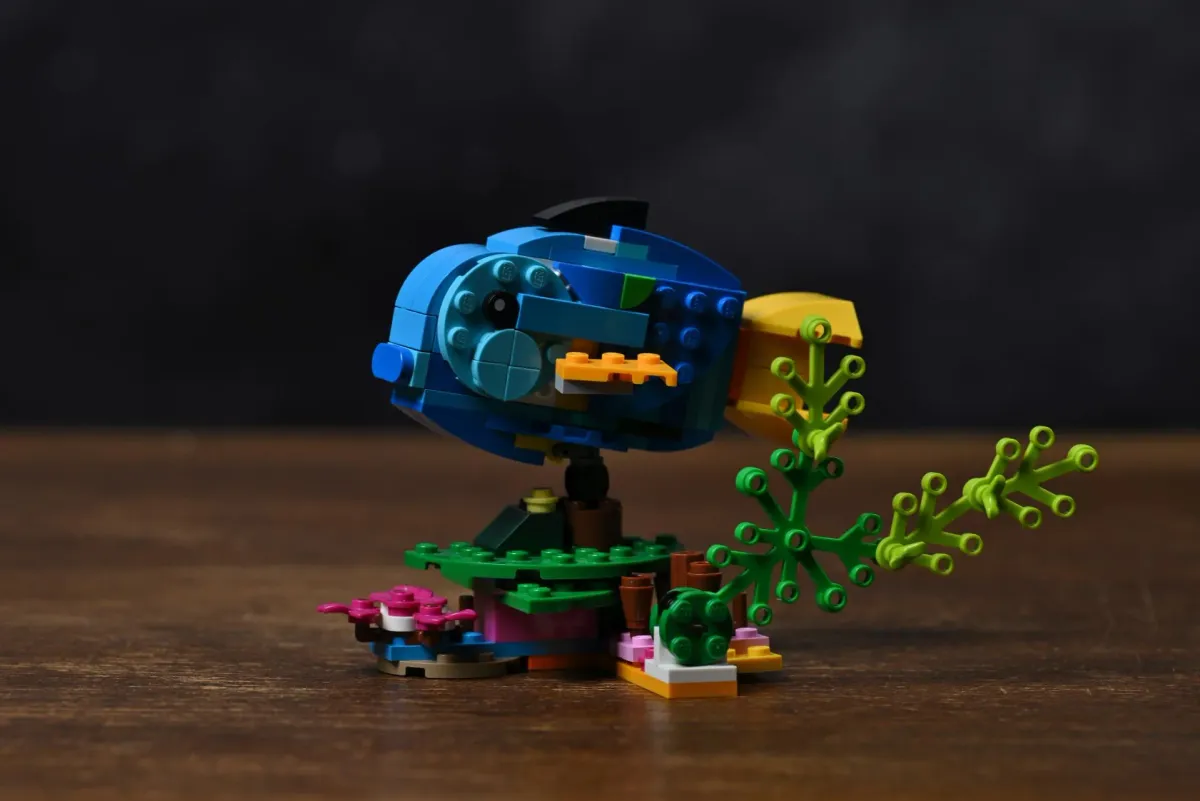 Side view of the fish build from LEGO Creator Exotic Parrot (31136), showing the blue body, yellow tail and seabed stand