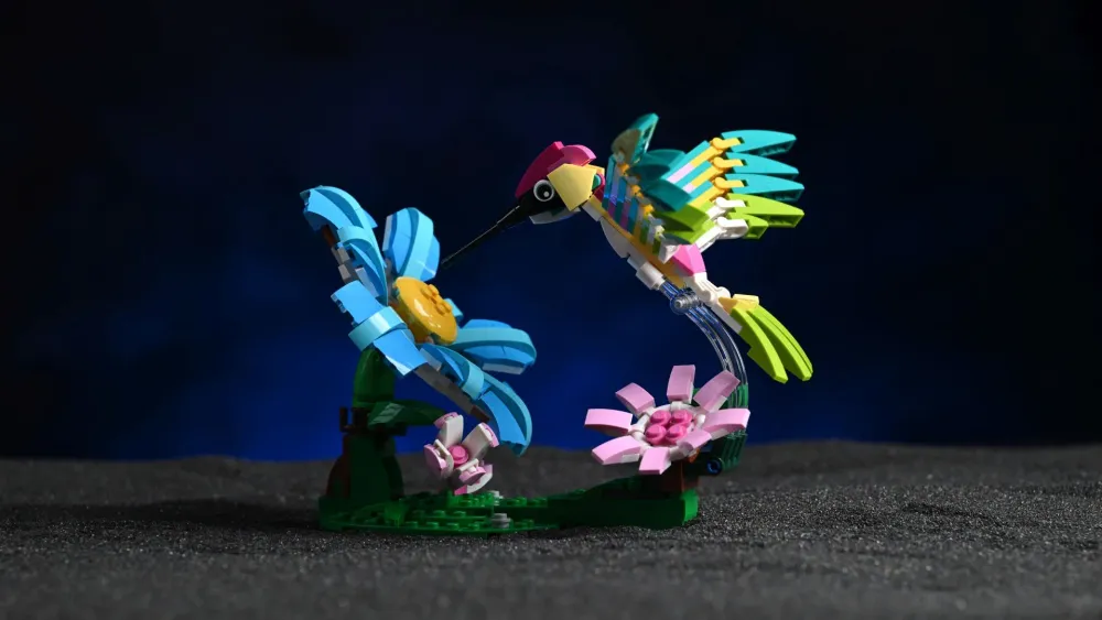 The LEGO Creator 3-in-1 Wild Animals: Colorful Hummingbird (31384) in its dynamic flying pose, hovering over its brick-built flower stand