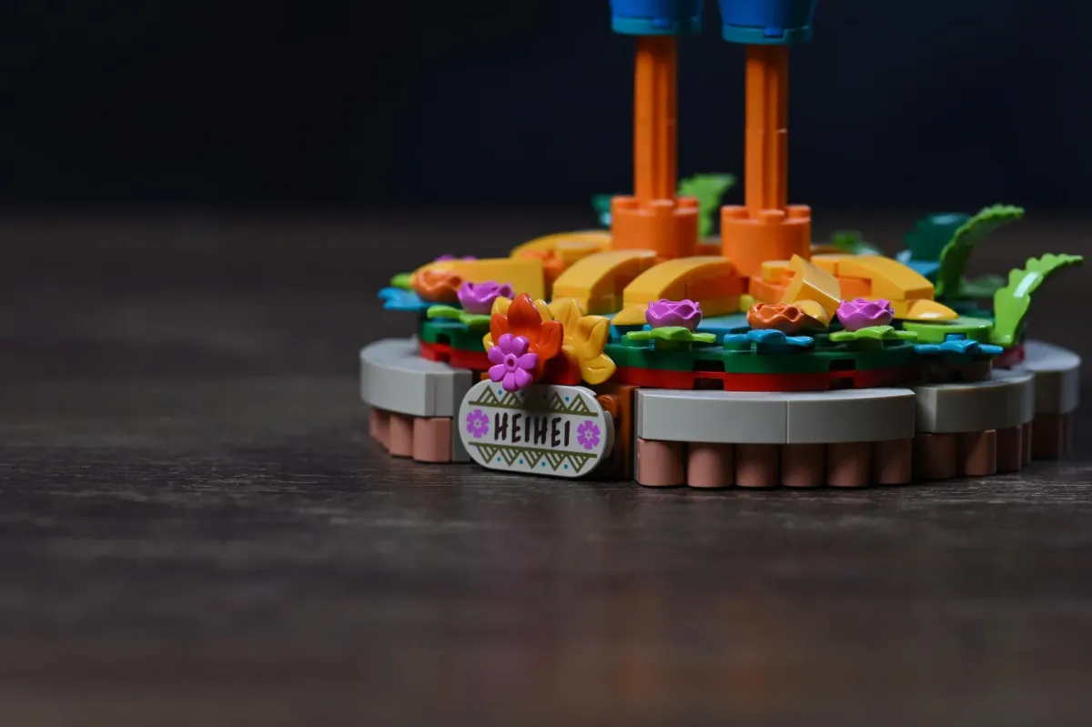 Close-up of the LEGO Disney Moana 2 Heihei (43272) flower-decorated display base with its HEIHEI nameplate
