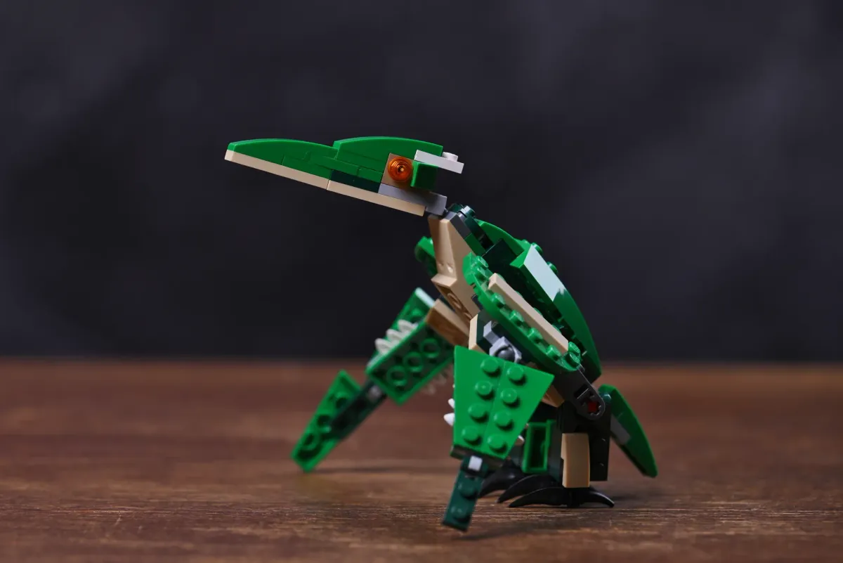 The finished Pterodactyl build of LEGO Creator Mighty Dinosaurs (31058), wings spread, photographed on a wooden table