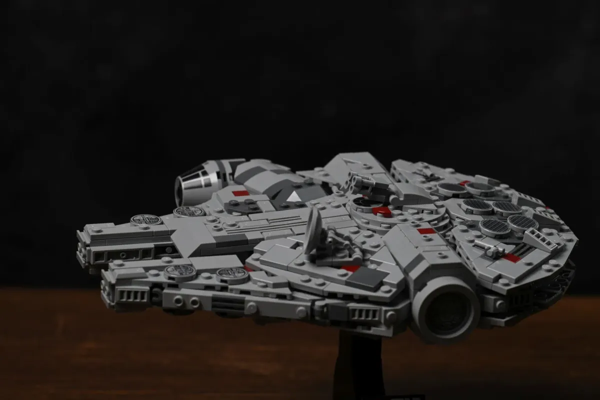 Three-quarter rear view of the finished LEGO Millennium Falcon (75375) on its display stand, showing the full saucer shape and rear engine housing