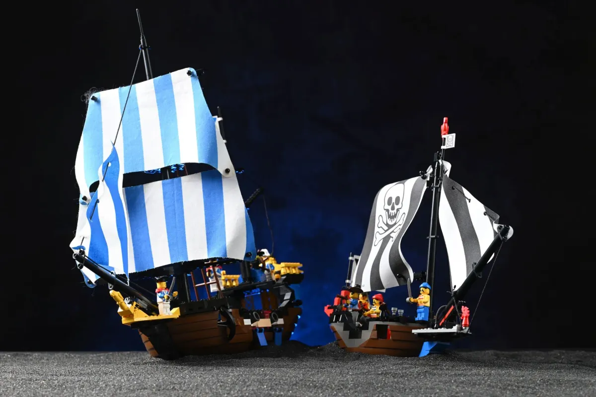LEGO Pirates Renegade Runner (6268) and LEGO Pirates Caribbean Clipper (6274) photographed side by side, the raider and the Governor's ship it was built to prey on