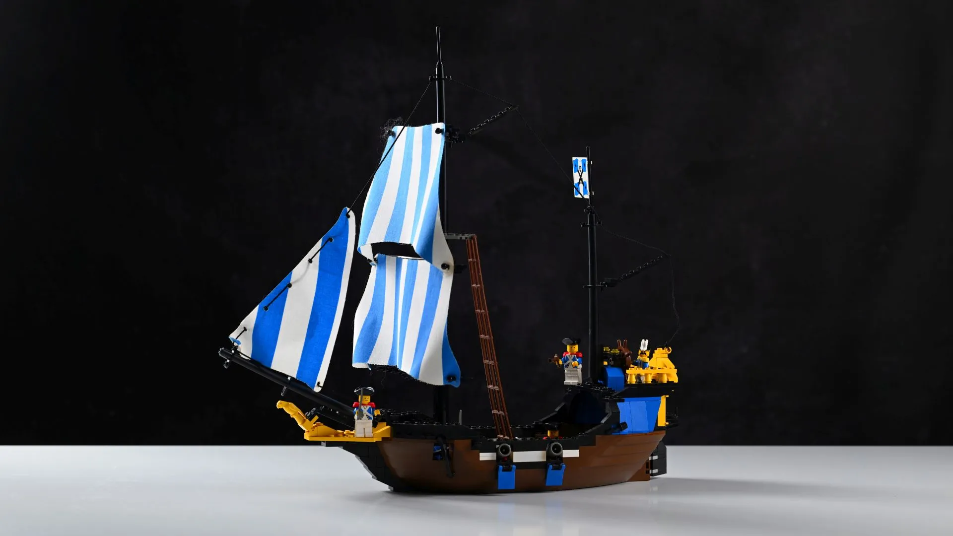 The complete LEGO Pirates Caribbean Clipper (6274) set from 1989, fully built after 37 years, with its blue-striped sails, twin cannons, and Imperial Soldier crew