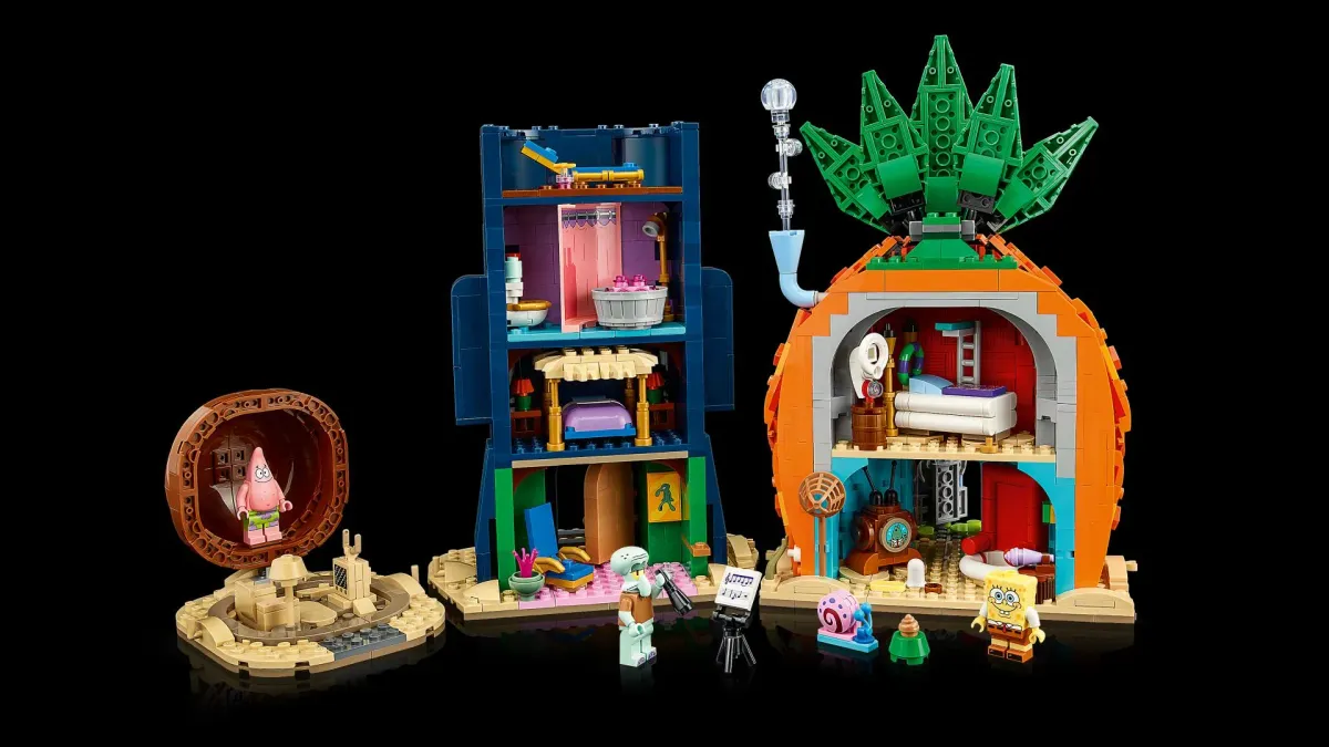 The LEGO Icons SpongeBob Bikini Bottom set 11386 opened up, showing the furnished interiors of the pineapple house and the four rooms inside Squidward's Easter Island head