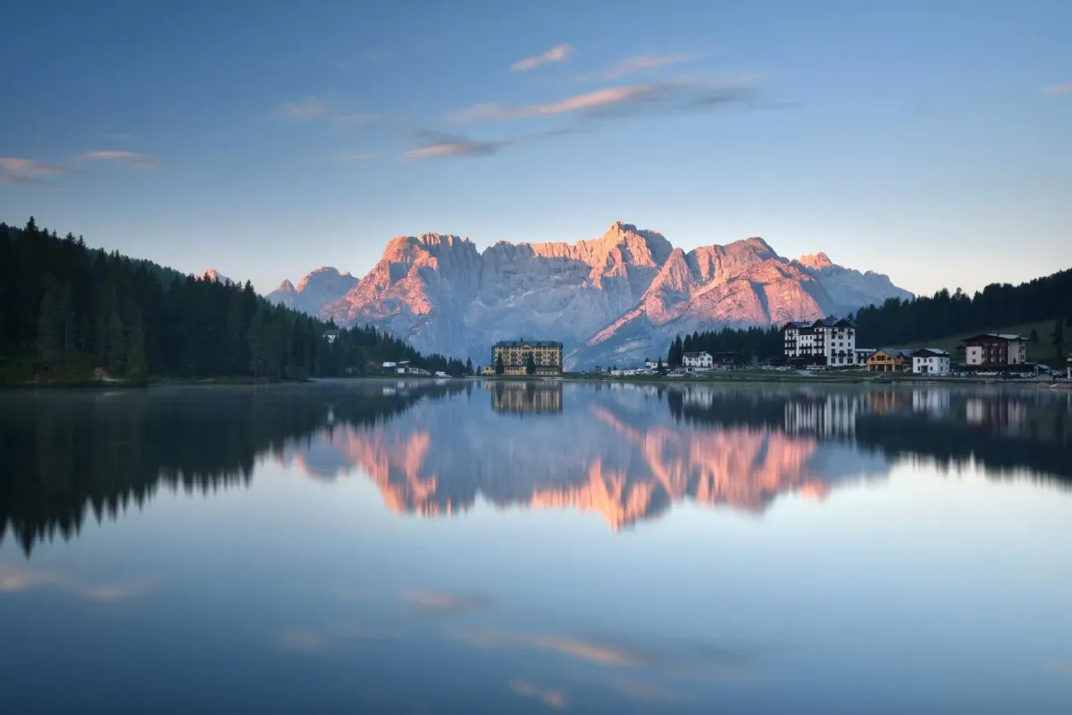 Lake Misurina in the Dolomites at sunrise, glass-flat water reflecting the Cadini di Misurina mountain peaks